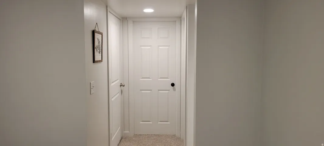 Finished Hallway featuring recessed lighting and brand new light colored carpet