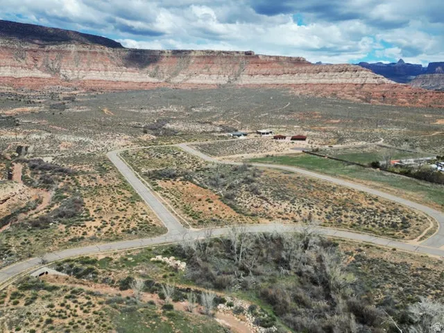 Aerial view of property and surrounding area with a mountain backdrop and rural landscape