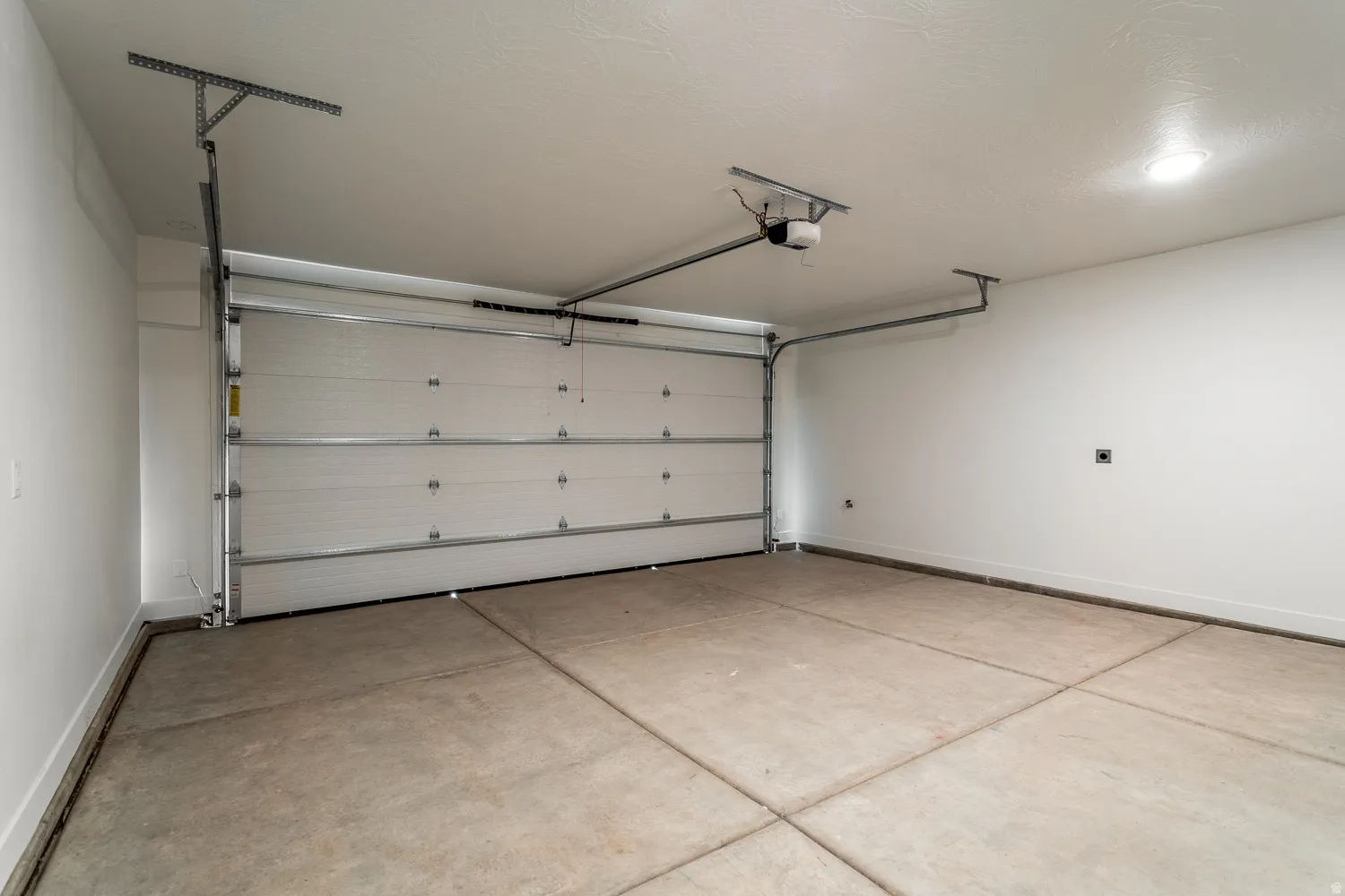 Garage featuring baseboards