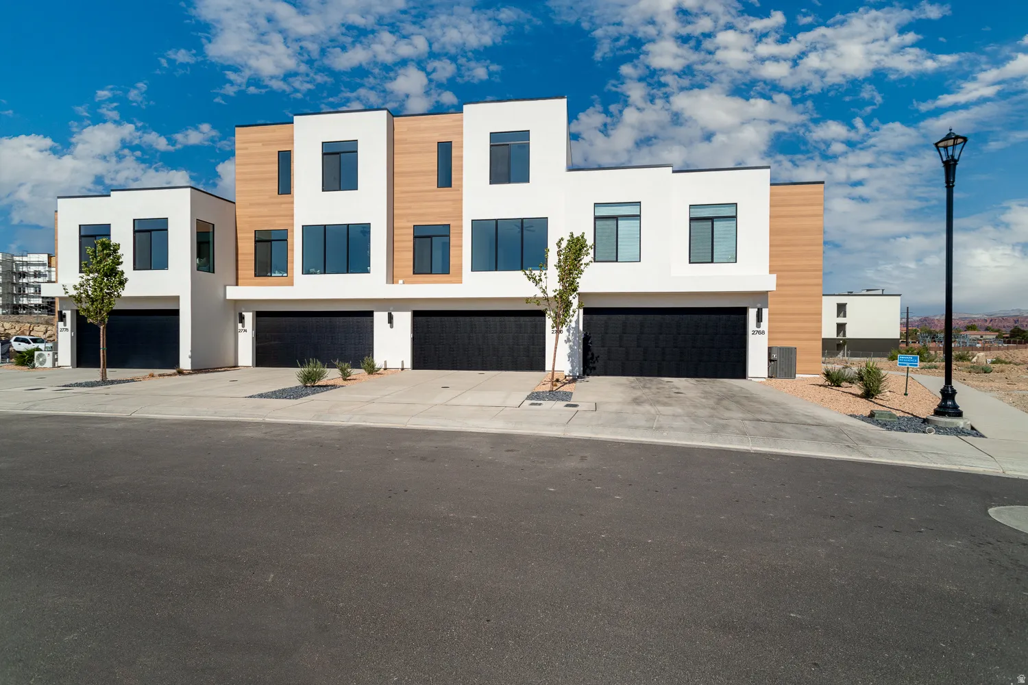 Contemporary home featuring stucco siding, concrete driveway, and an attached garage