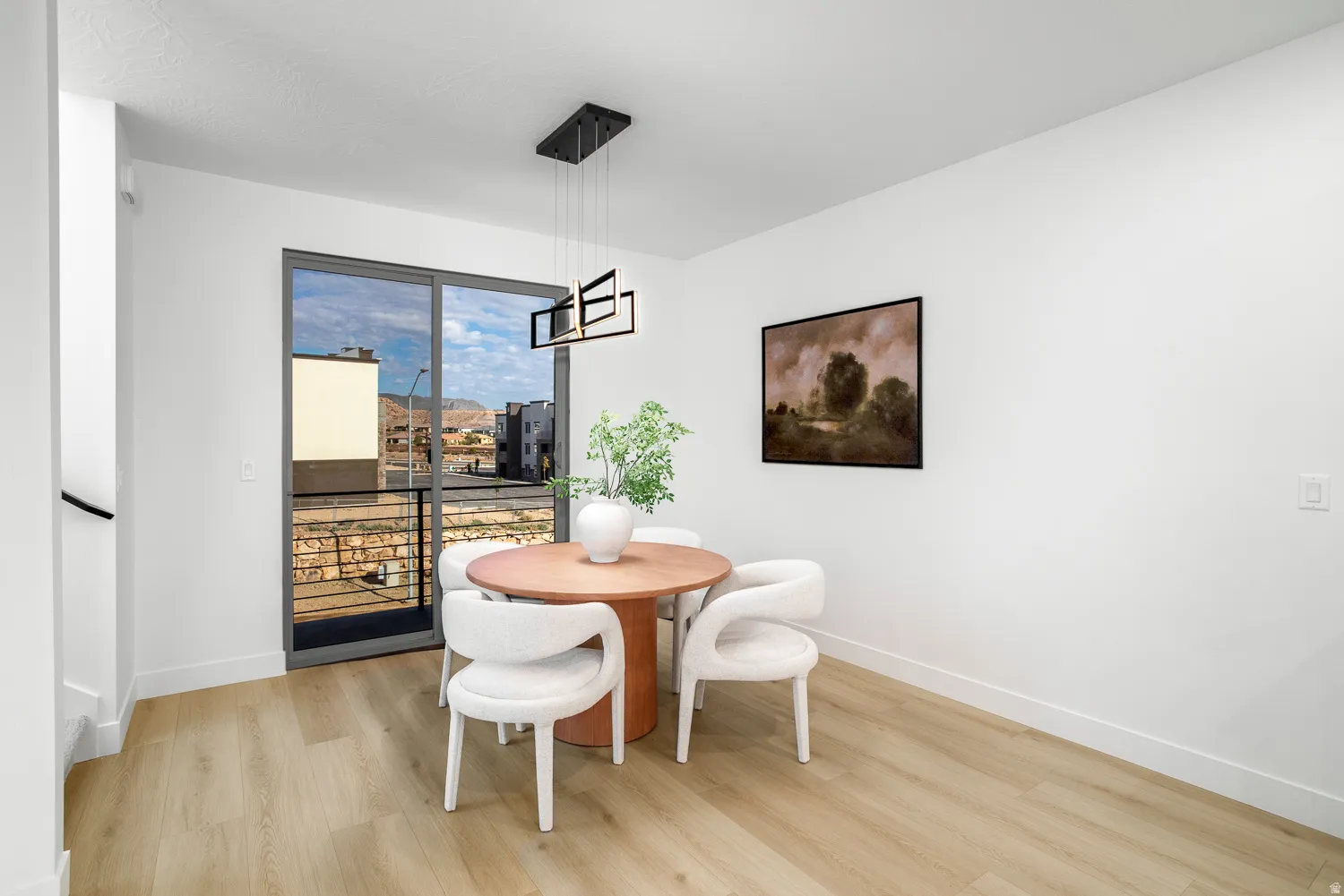 Dining area with light wood-style floors and baseboards