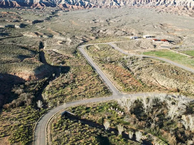 Aerial overview of property's location with rural landscape and a mountainous background