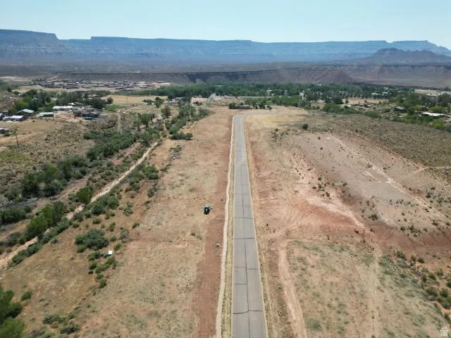 Aerial overview of property's location featuring a mountainous background and rural landscape