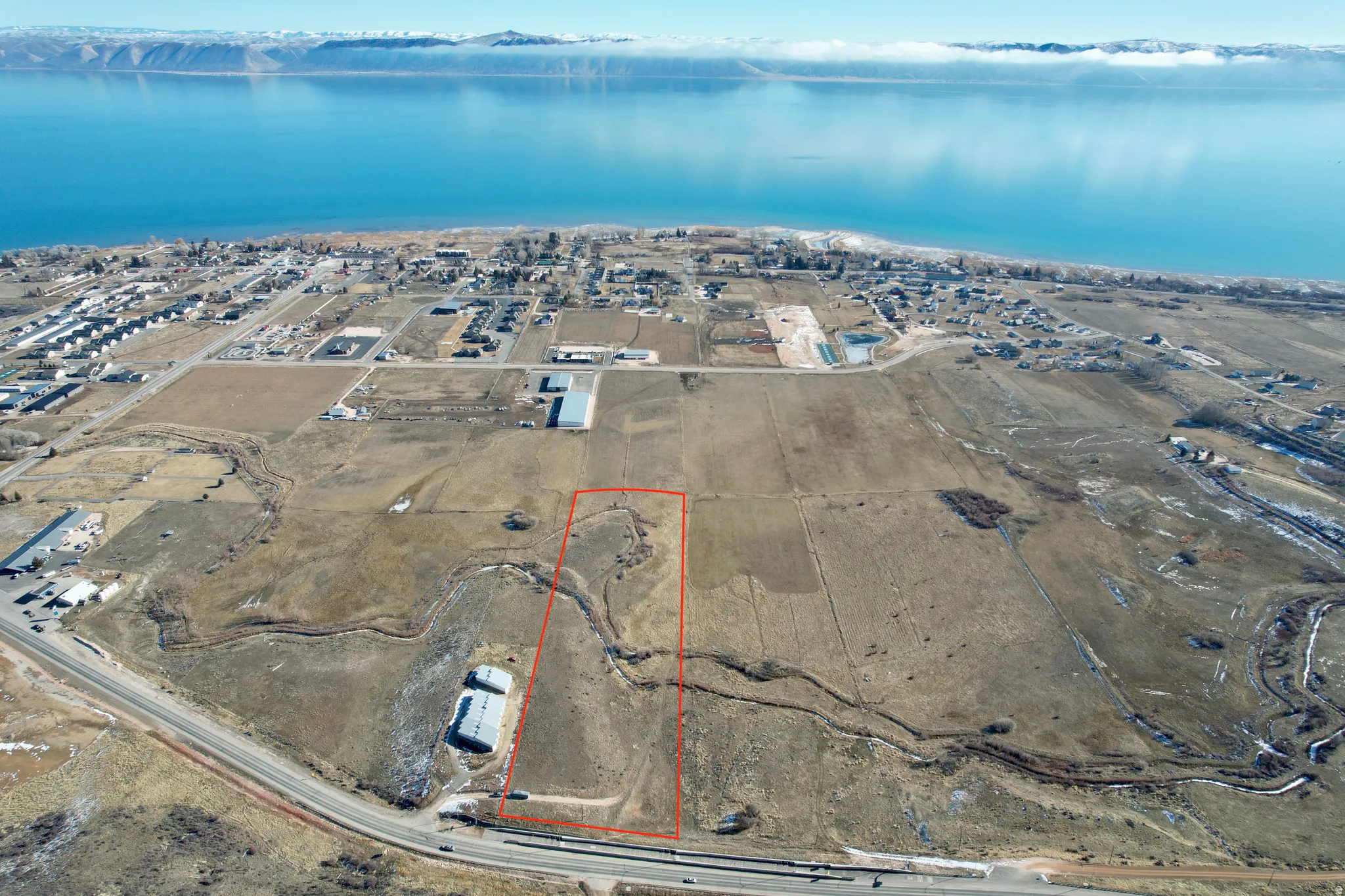 View of property location with a large body of water and property parcel outlined