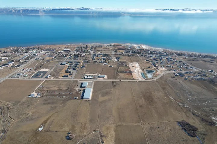 Aerial overview of property's location featuring a large body of water and nearby suburban area