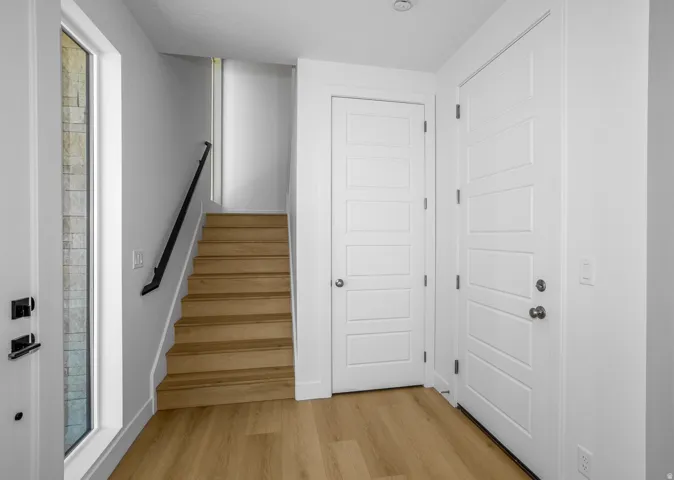 Staircase featuring wood finished floors