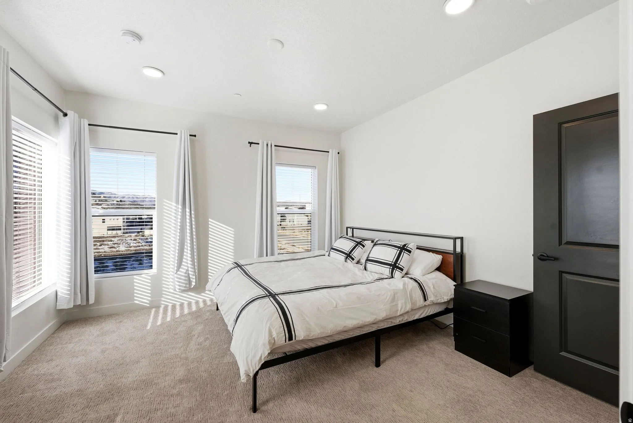 Bedroom featuring light colored carpet and recessed lighting