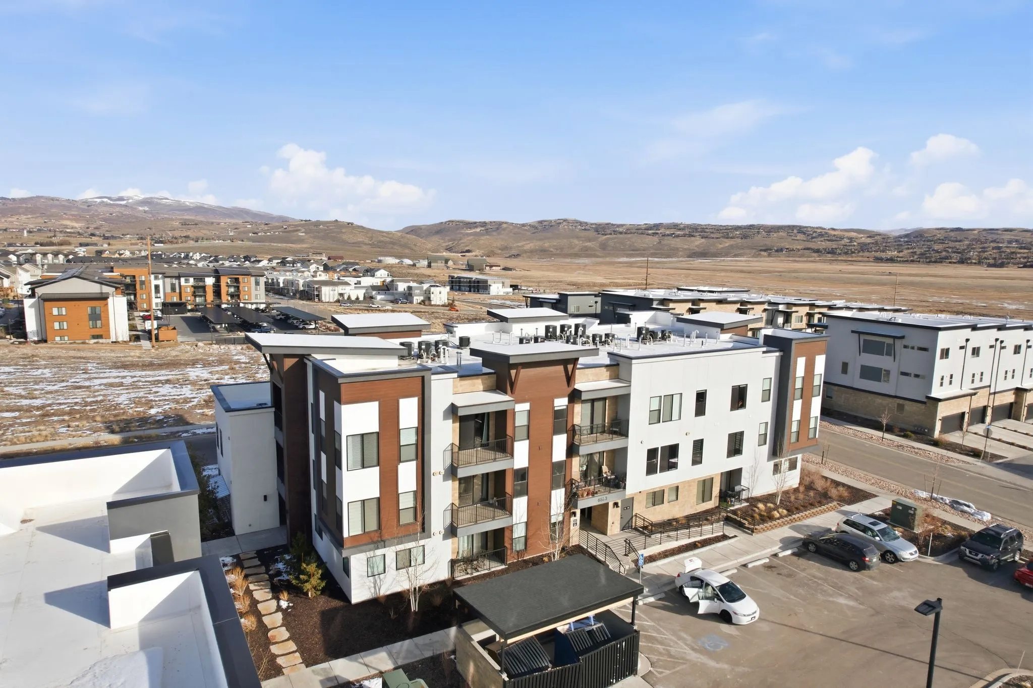 Aerial view of residential area featuring a mountainous background