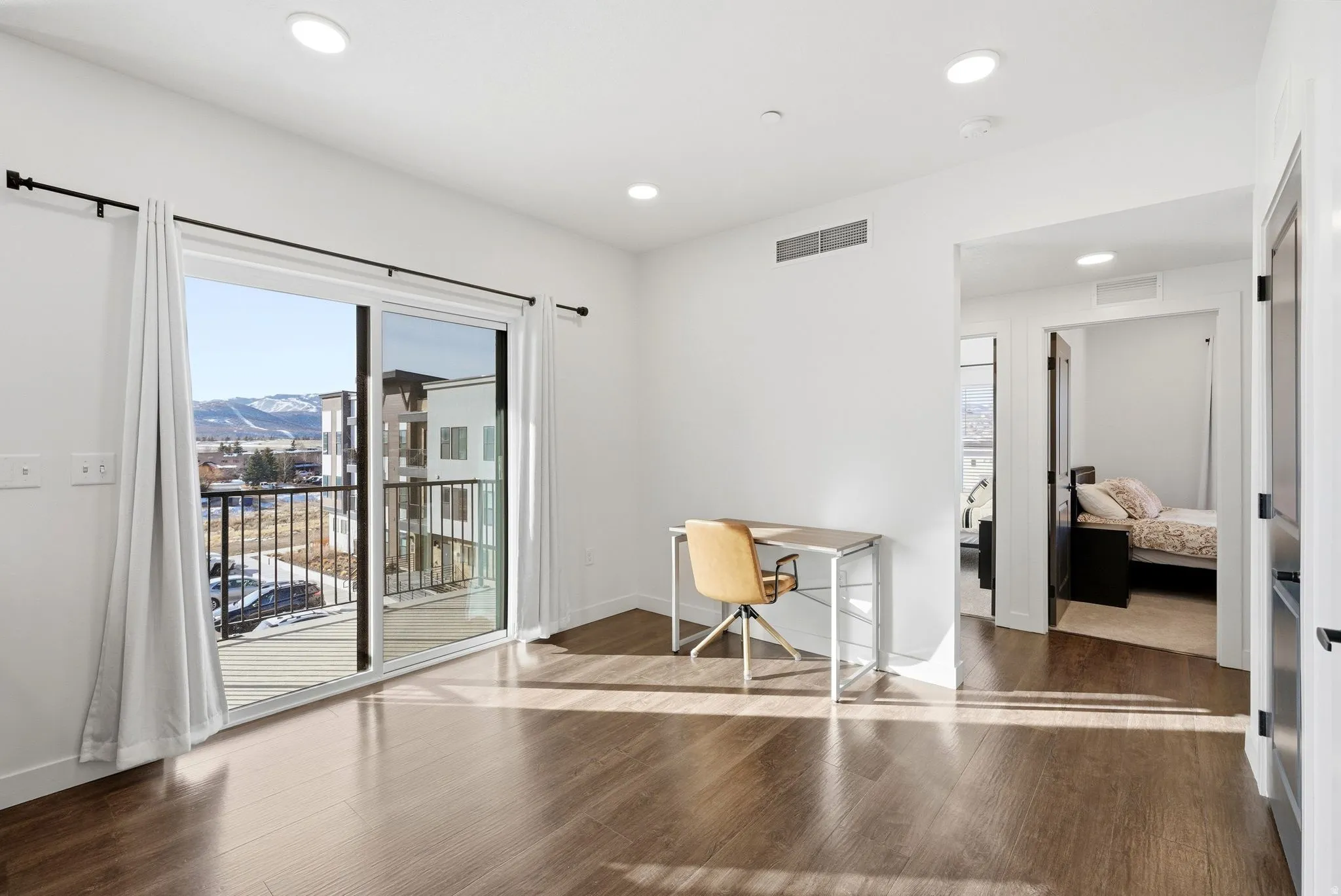Office space with dark wood-type flooring, recessed lighting, and a mountain view