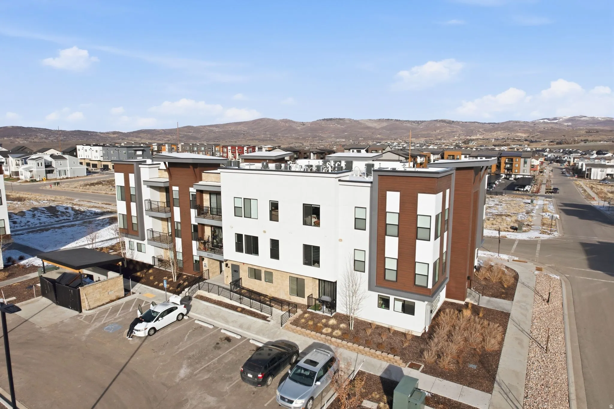 Aerial perspective of suburban area featuring a mountainous background
