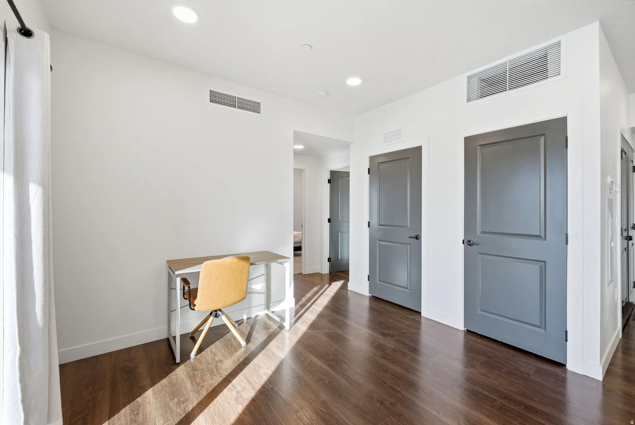 Unfurnished office with dark wood-style flooring and recessed lighting