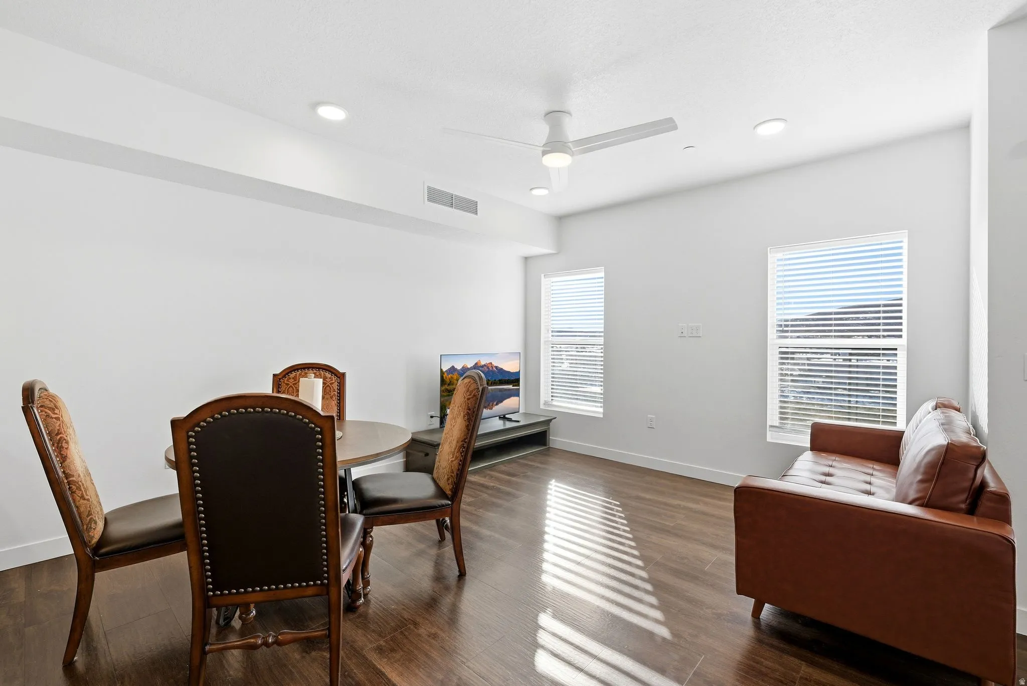 Dining space featuring ceiling fan, dark wood finished floors, and recessed lighting