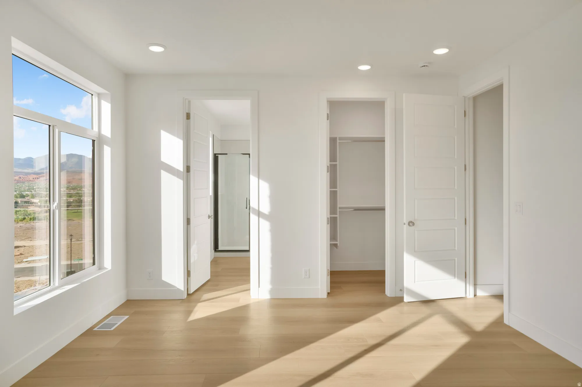 Bright interior featuring wood-finish flooring and recessed lighting