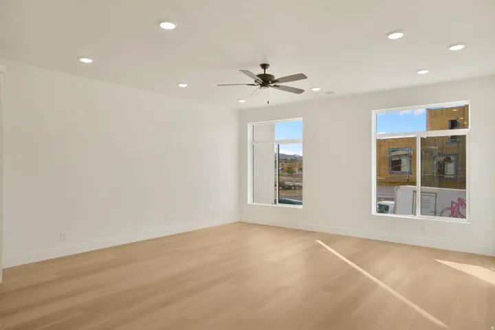 Expansive interior space featuring light wood-finish flooring and recessed lighting