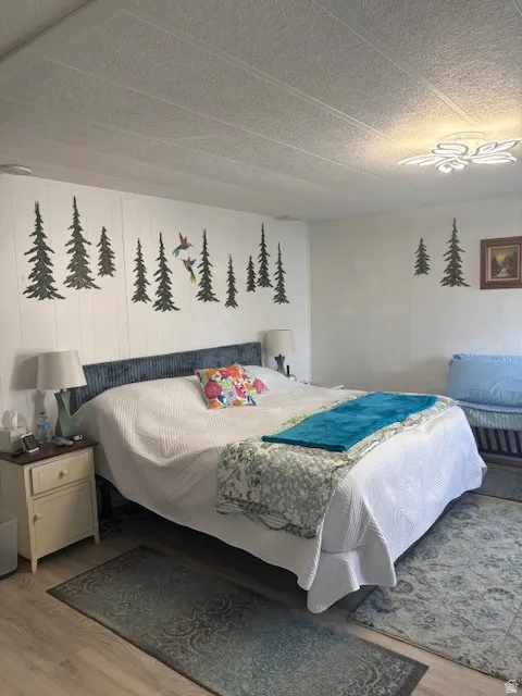 Bedroom featuring light wood-style floors and a textured ceiling