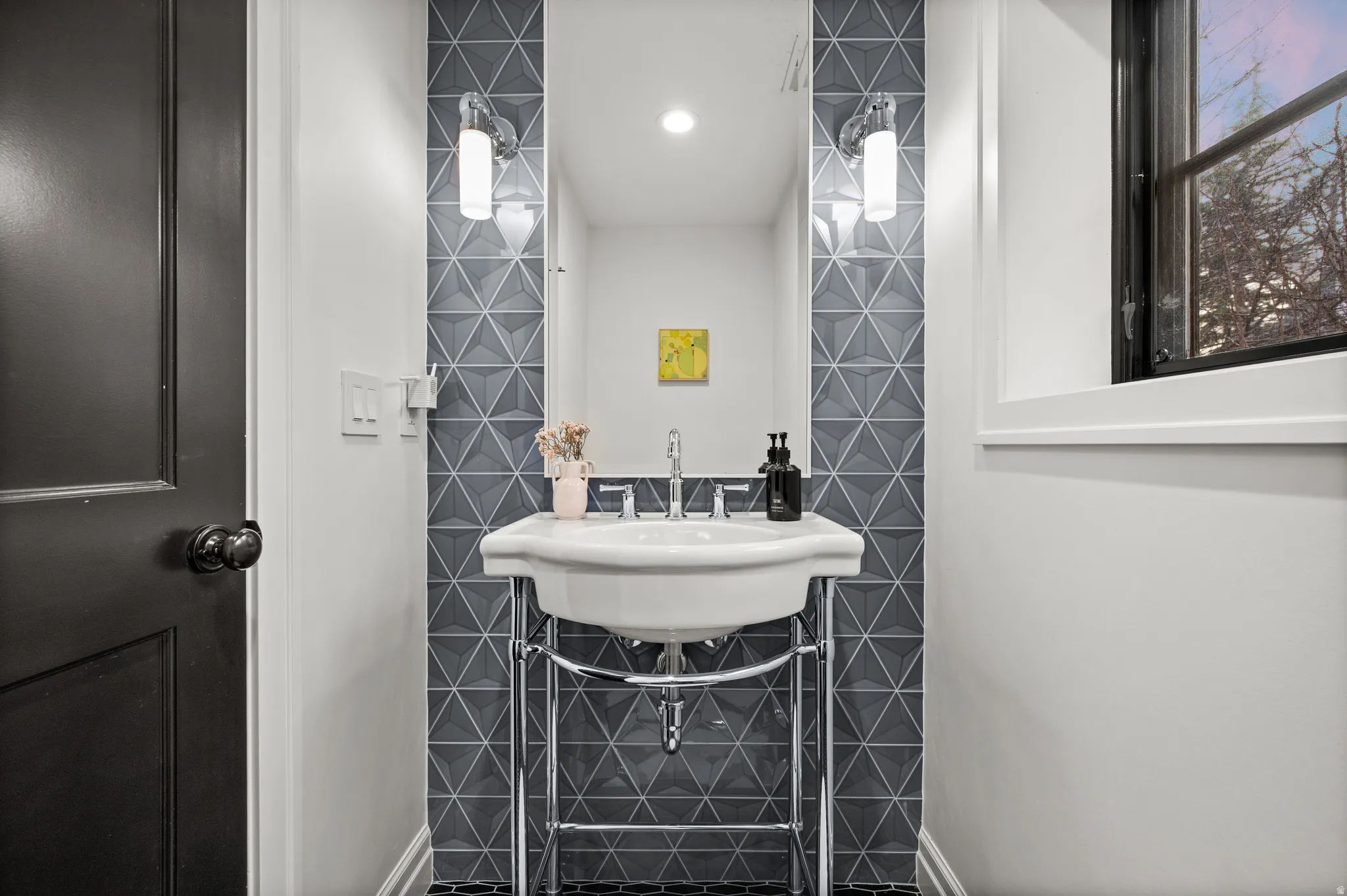 Half bathroom featuring tile walls and a sink