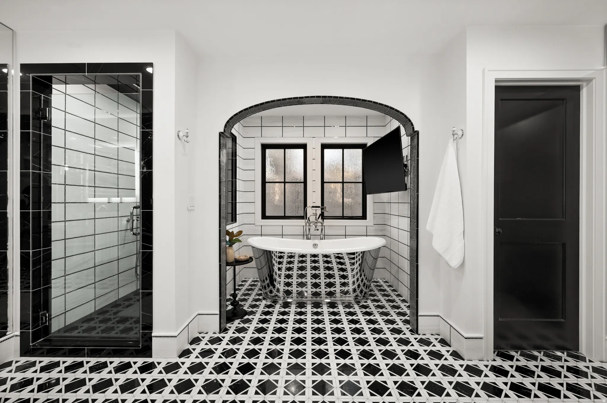 Master full bathroom with a freestanding tub, a stall shower, and tile walls