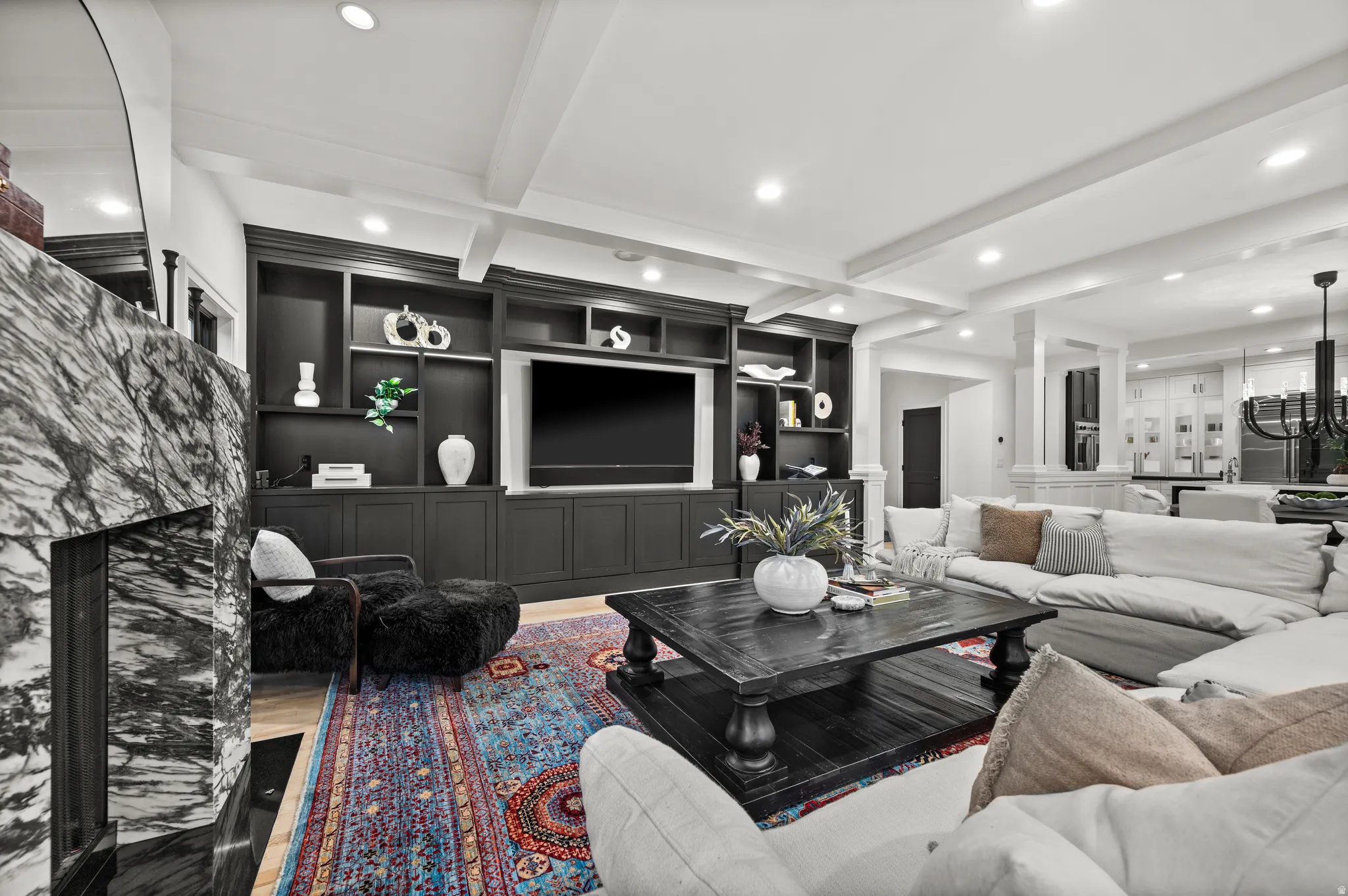 Living area featuring beam ceiling, recessed lighting, wood finished floors, built in features, and a fireplace