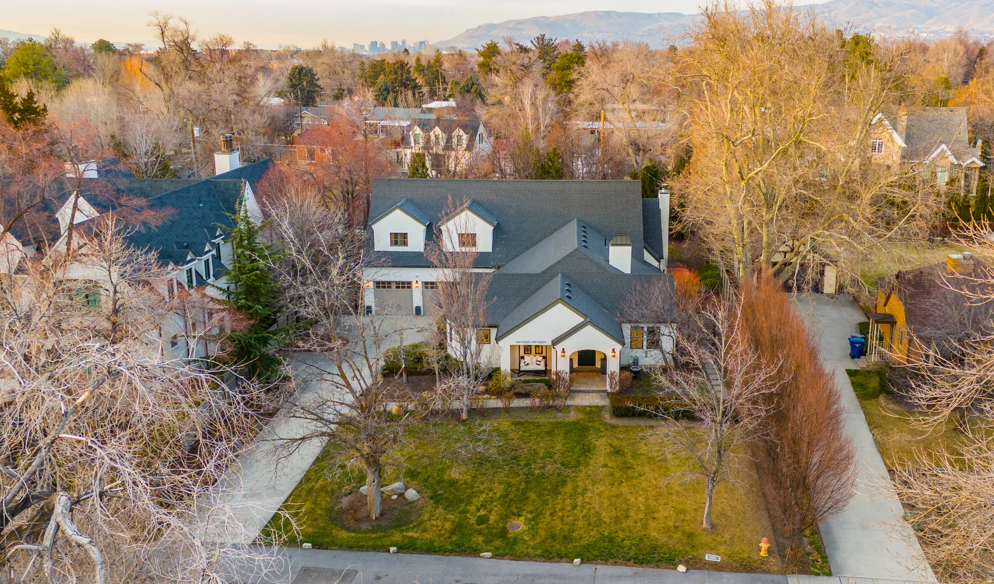 Aerial view at dusk of view of wooded area and a residential view