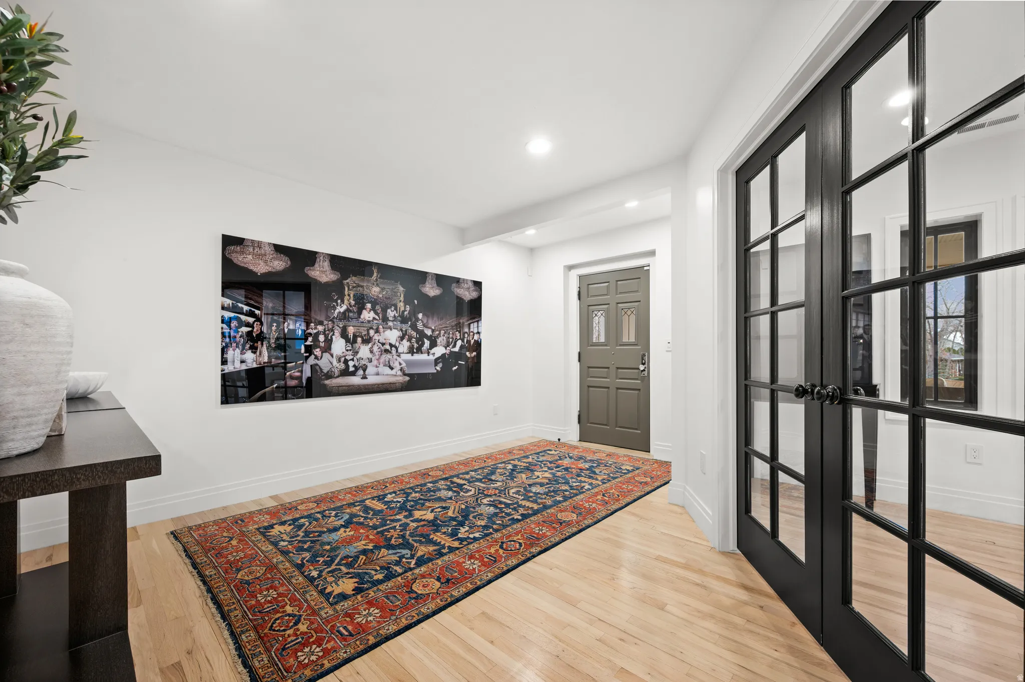 Entrance foyer with light wood-style flooring, recessed lighting, and french doors
