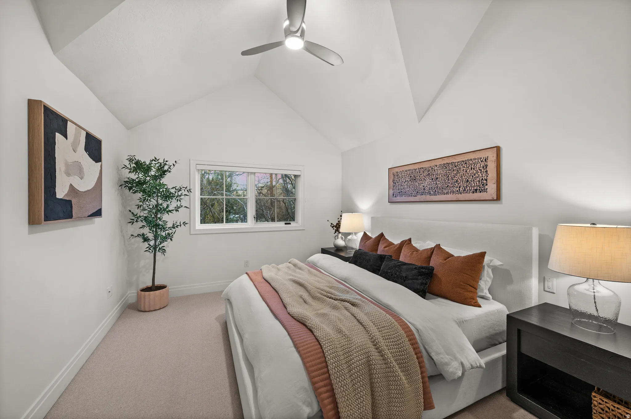 Bedroom featuring carpet floors, lofted ceiling, and ceiling fan