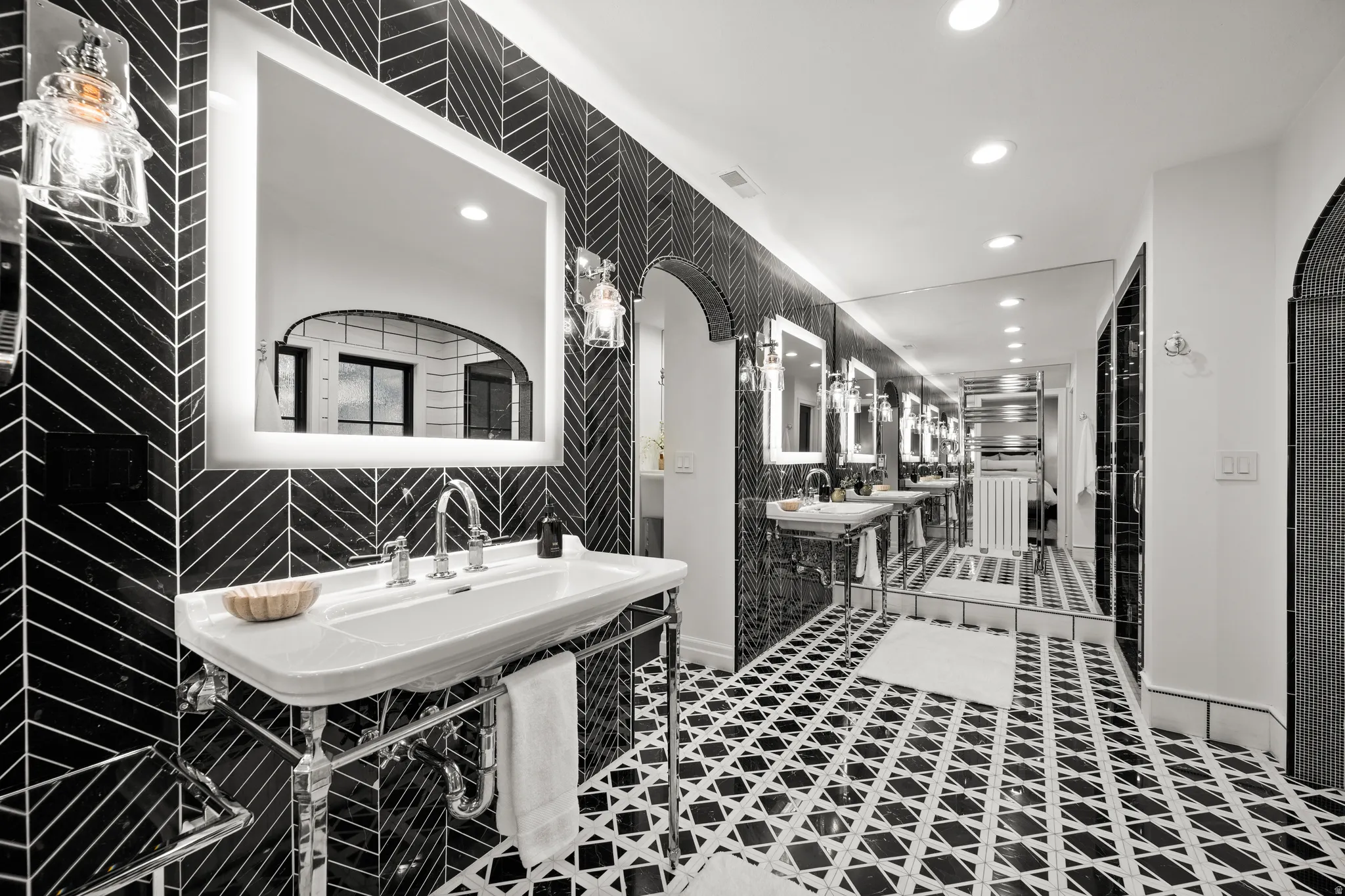 Master Bathroom with recessed lighting, two sinks, and tile walls
