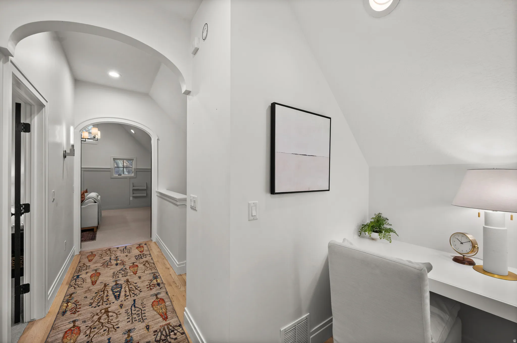 Bathroom with lofted ceiling, recessed lighting, and light wood-type flooring