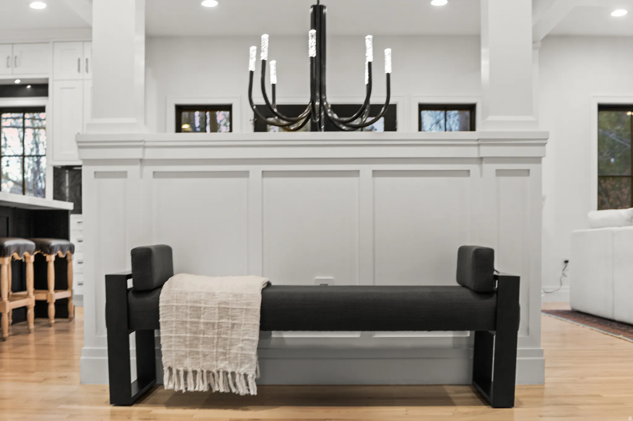 Detailed view of recessed lighting, wood finished floors, and a chandelier