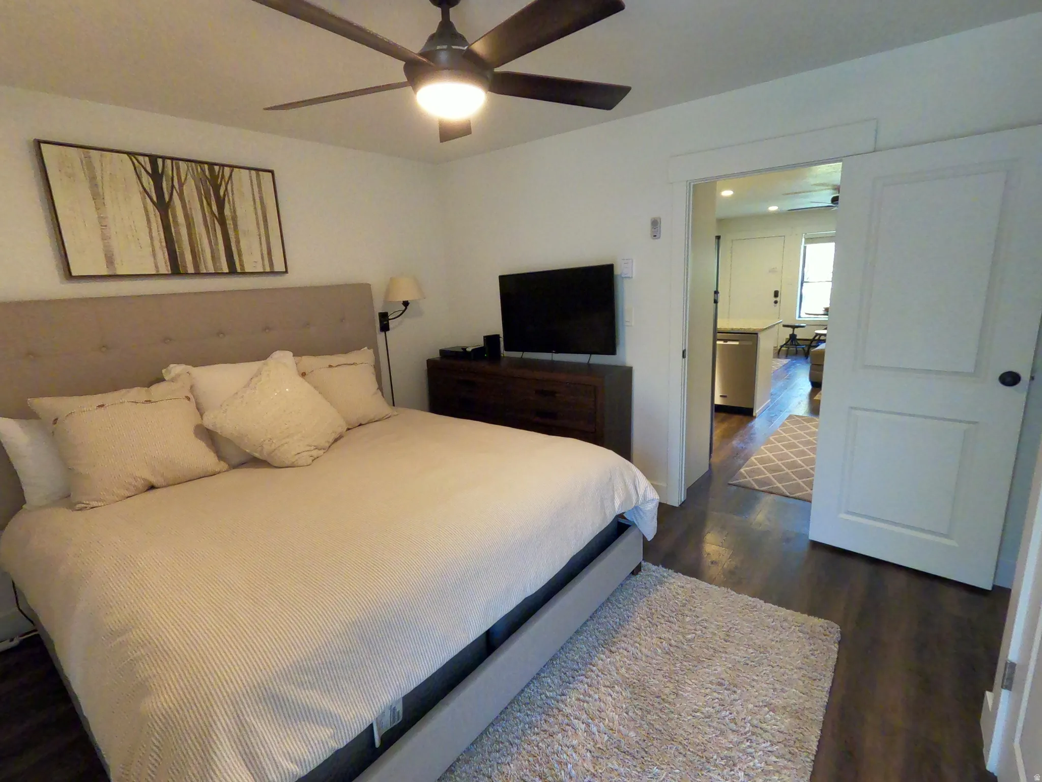 Bedroom with dark wood-style floors and a ceiling fan