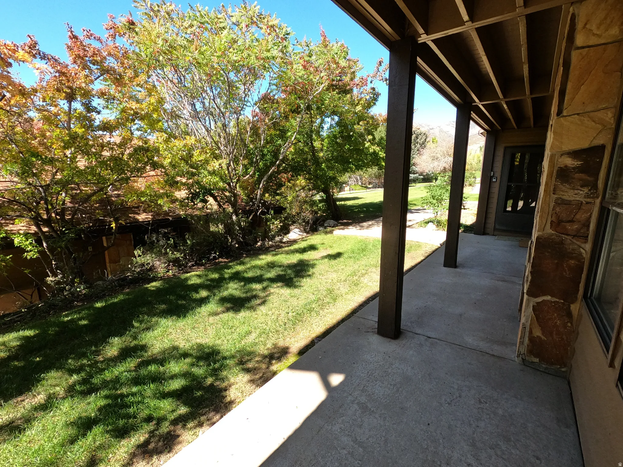 View of grassy yard with a patio