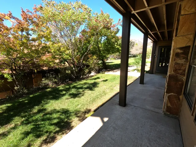View of grassy yard with a patio