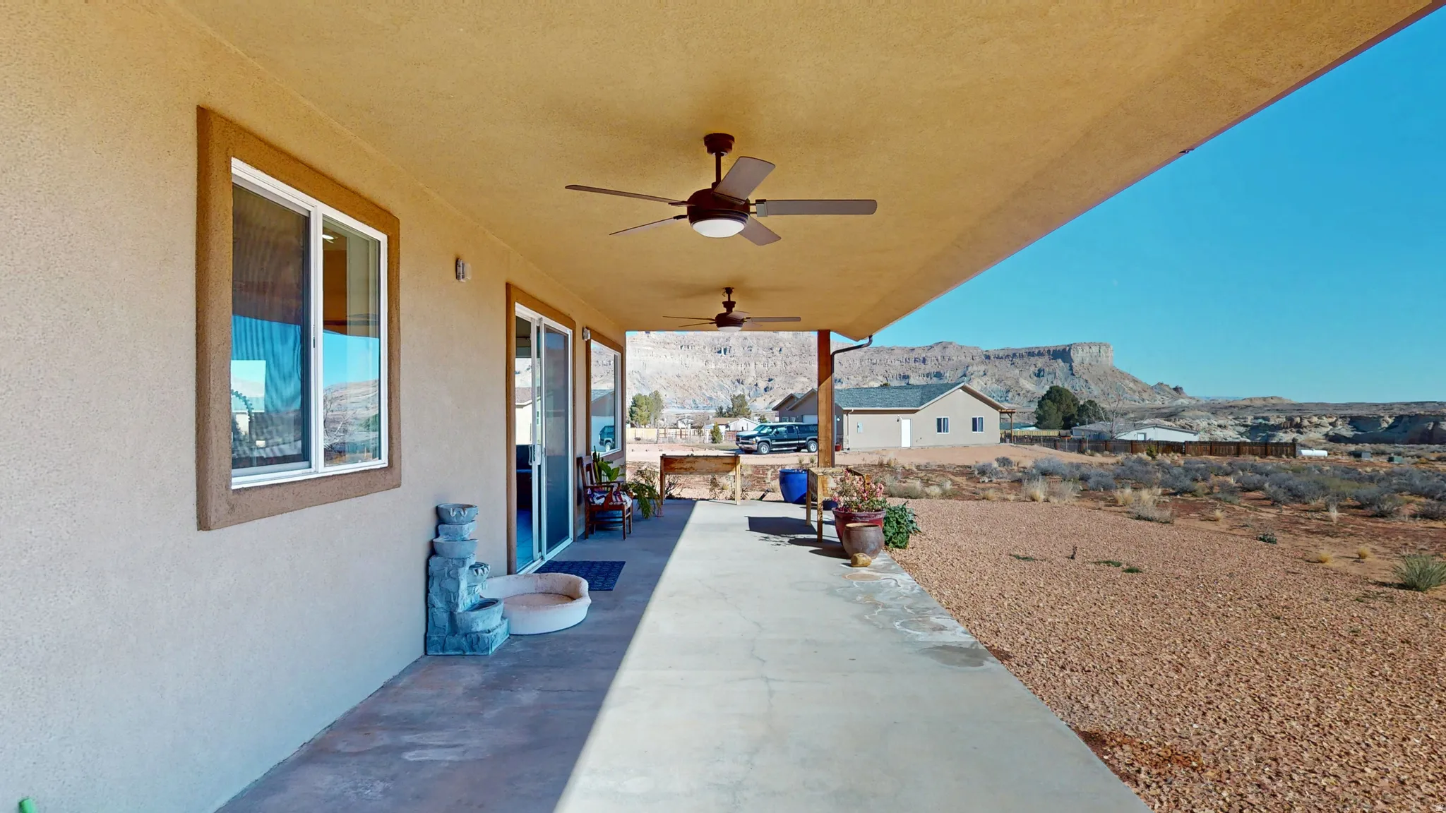 View of patio with ceiling fan and a mountain view