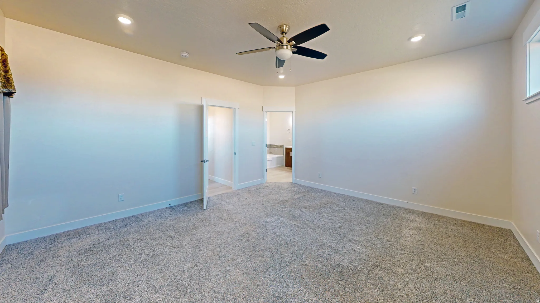 Unfurnished bedroom featuring a ceiling fan, carpet flooring, recessed lighting, and connected bathroom