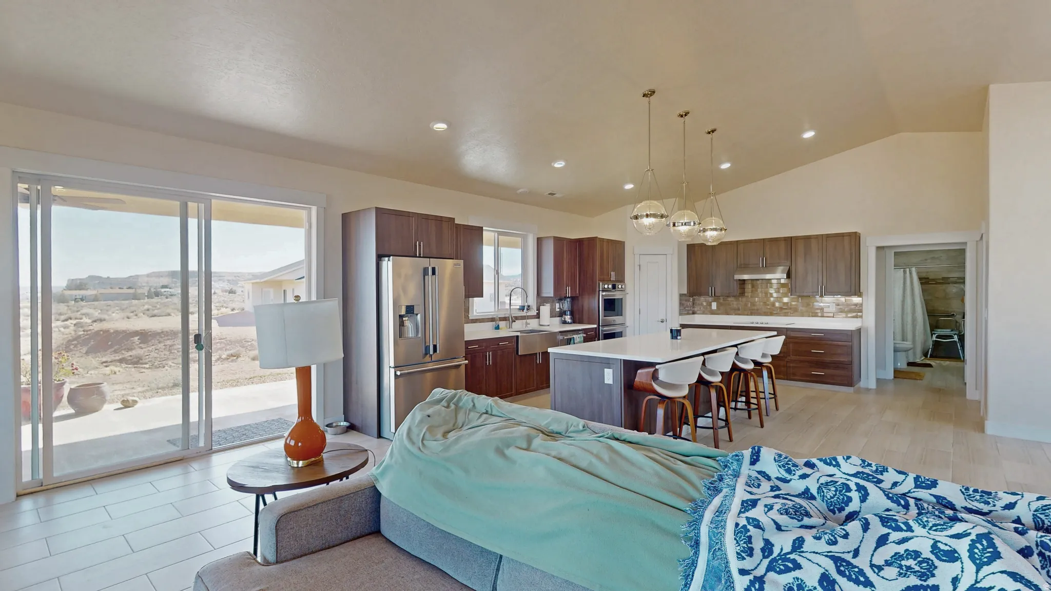 Living area featuring recessed lighting, high vaulted ceiling, and light wood-type flooring