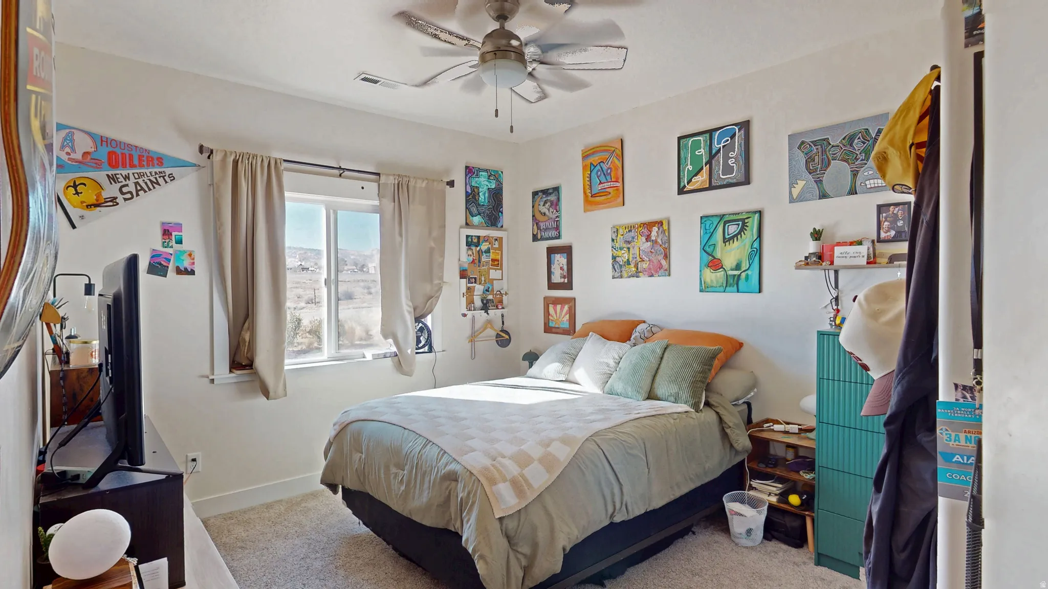 Carpeted bedroom with a ceiling fan and baseboards