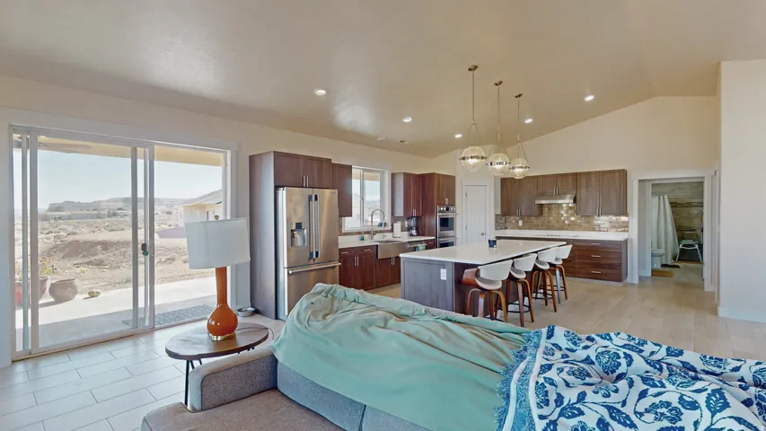 Living area featuring recessed lighting, high vaulted ceiling, and light wood-type flooring