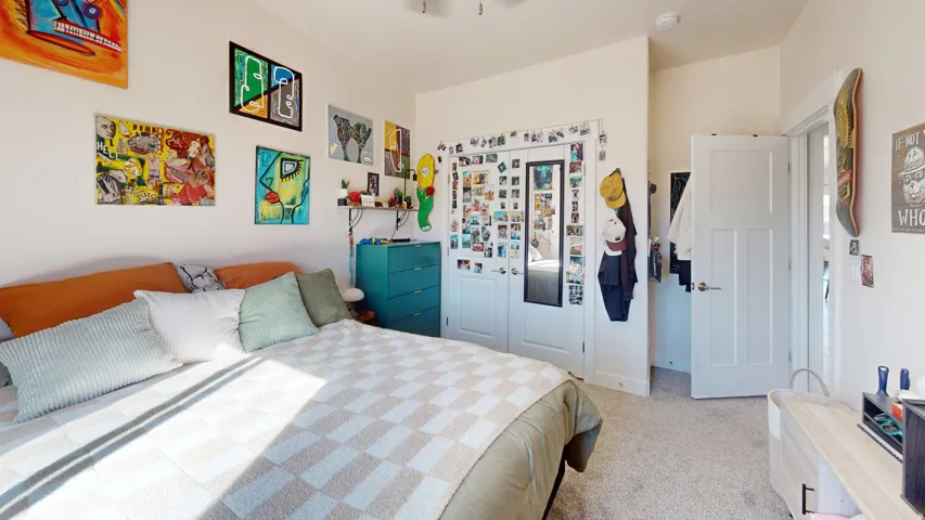 Bedroom with a closet and light carpet