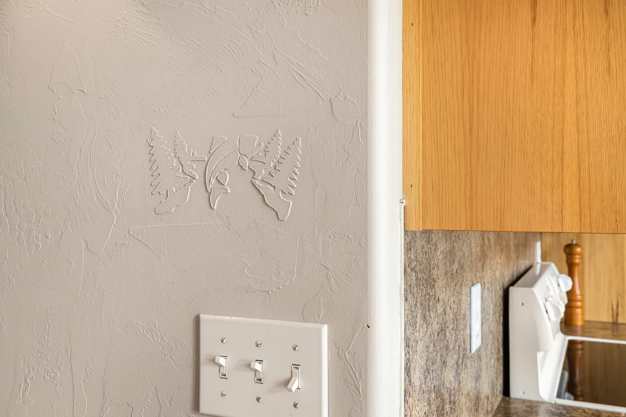 Detailed view of a textured wall and white range oven