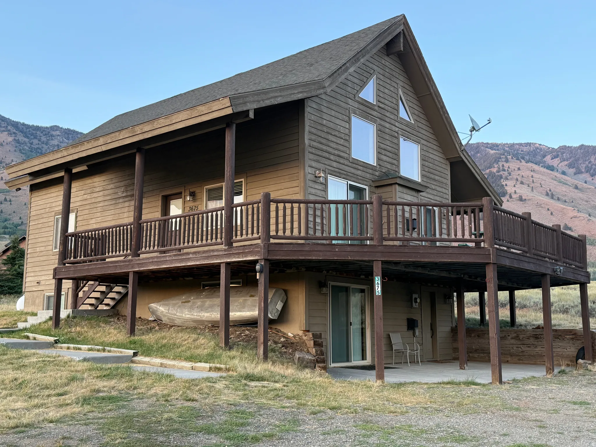 View of property exterior with a deck with mountain view