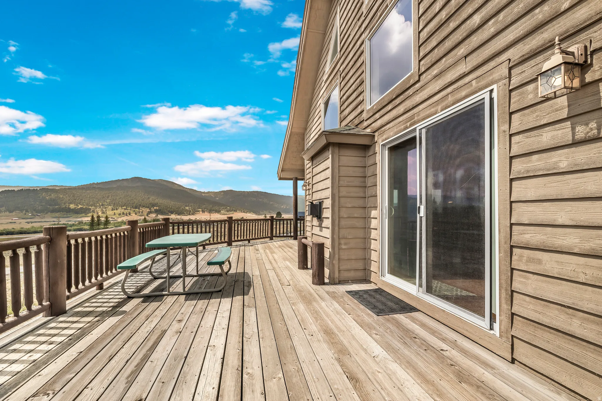 Wooden terrace featuring a mountain view