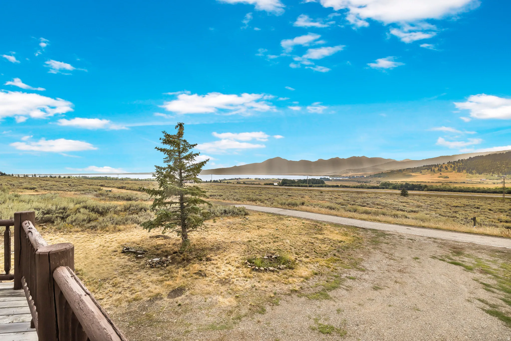 View of yard with a rural view and a mountain view