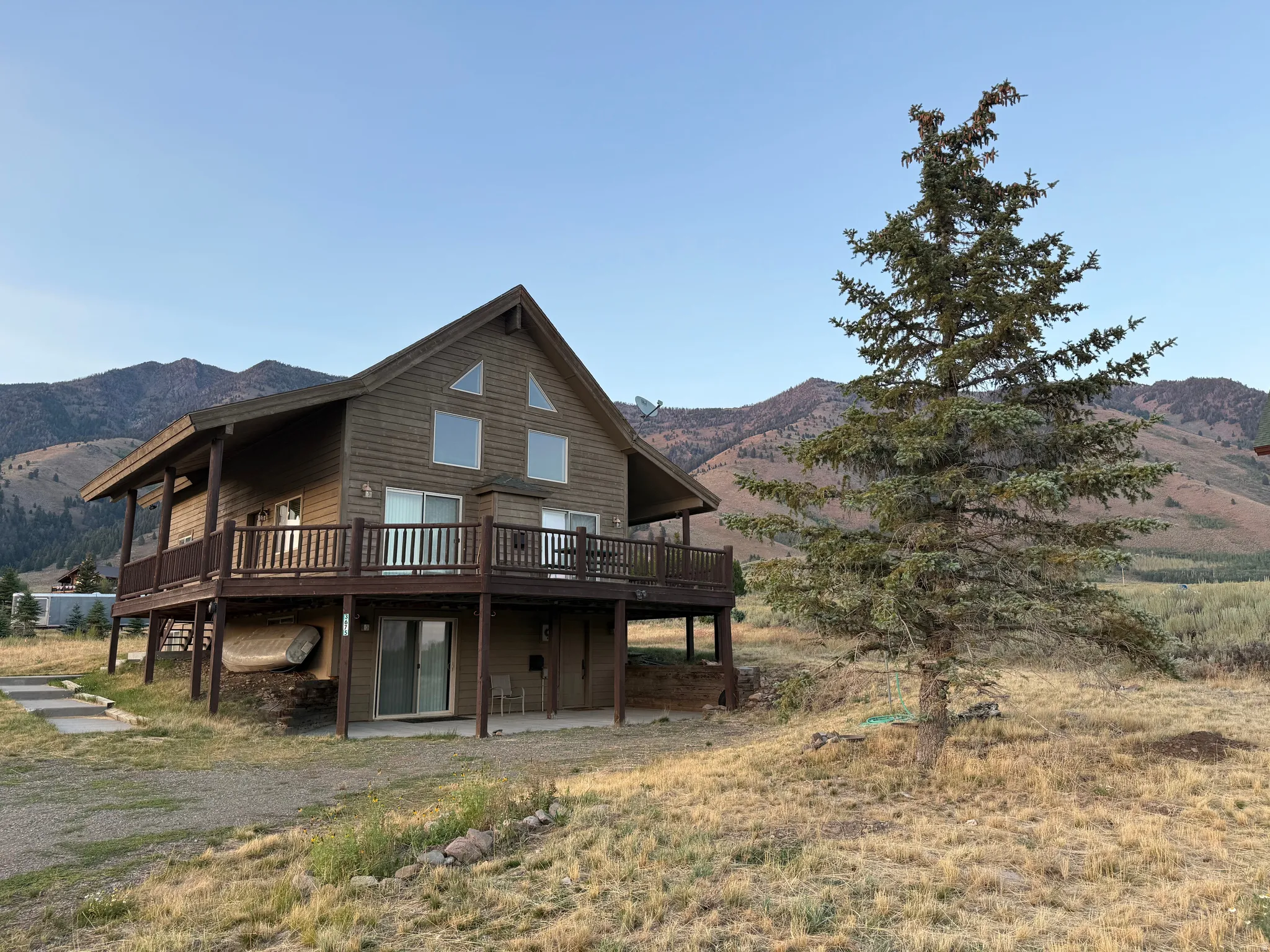 Rear view of house with a deck with mountain view