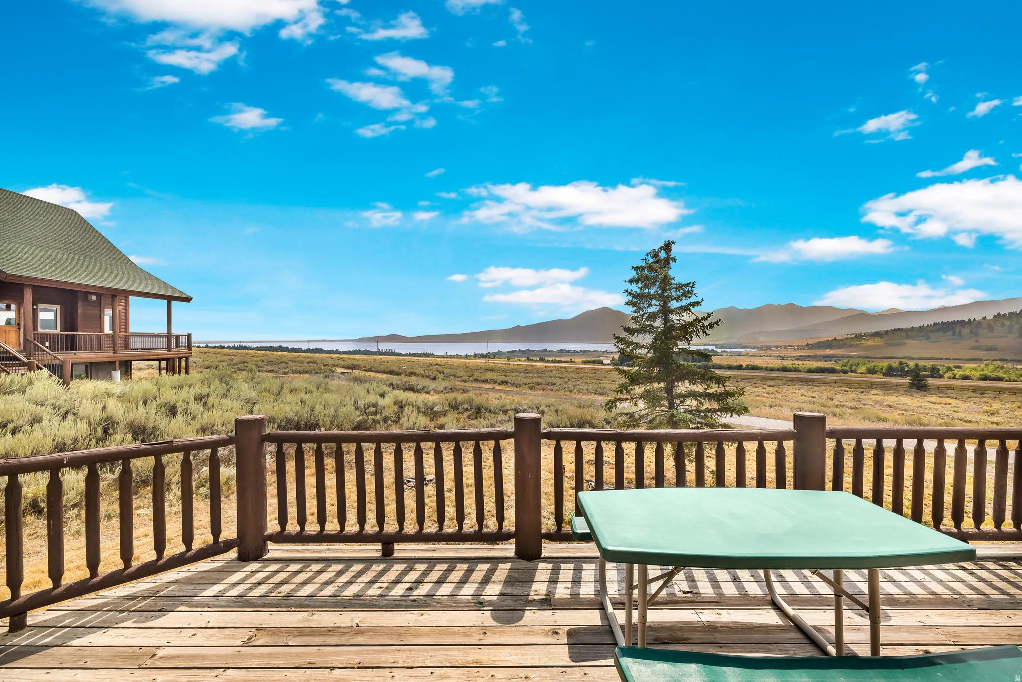 Wooden deck featuring a mountain view and a view of countryside