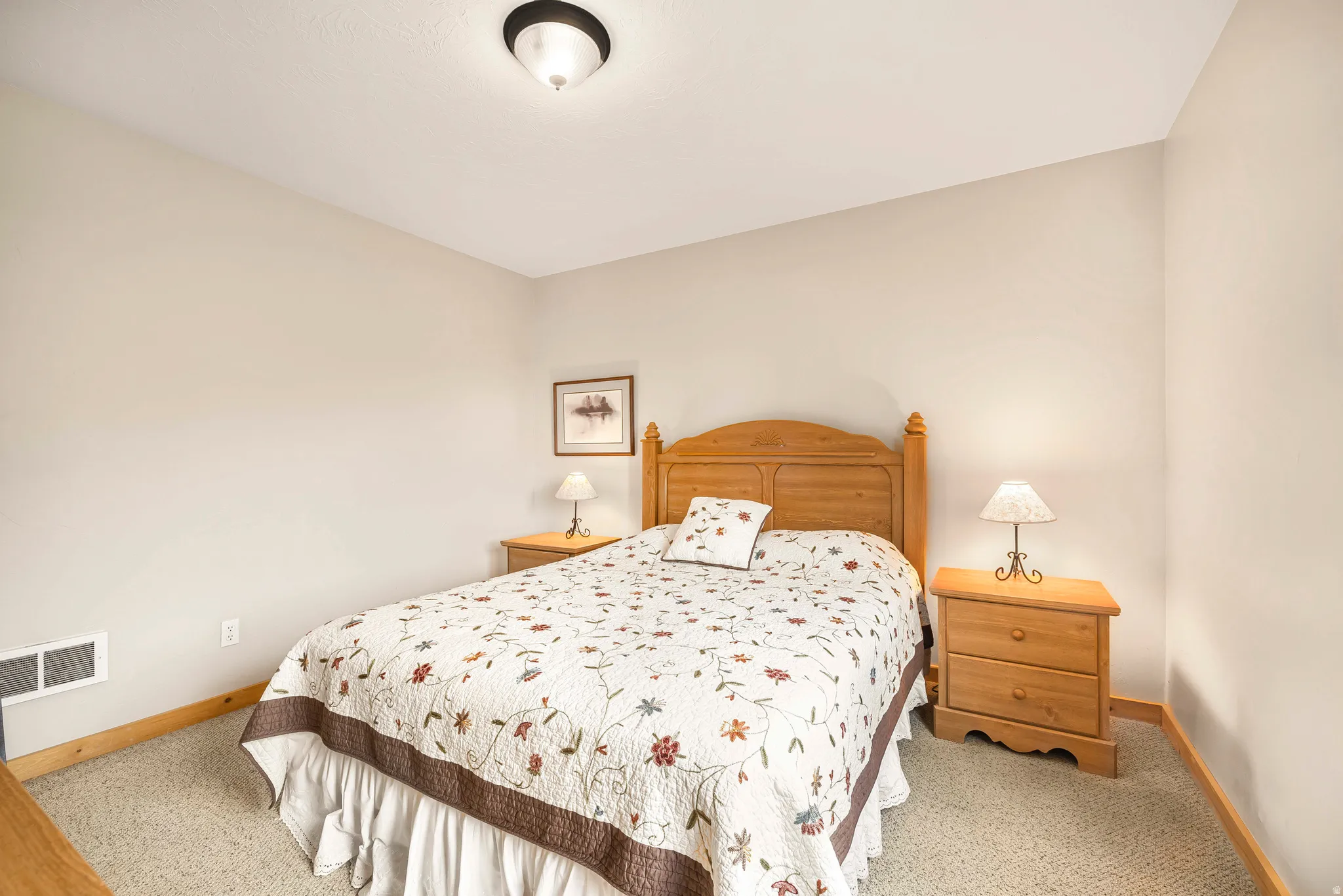 Bedroom with baseboards and light colored carpet
