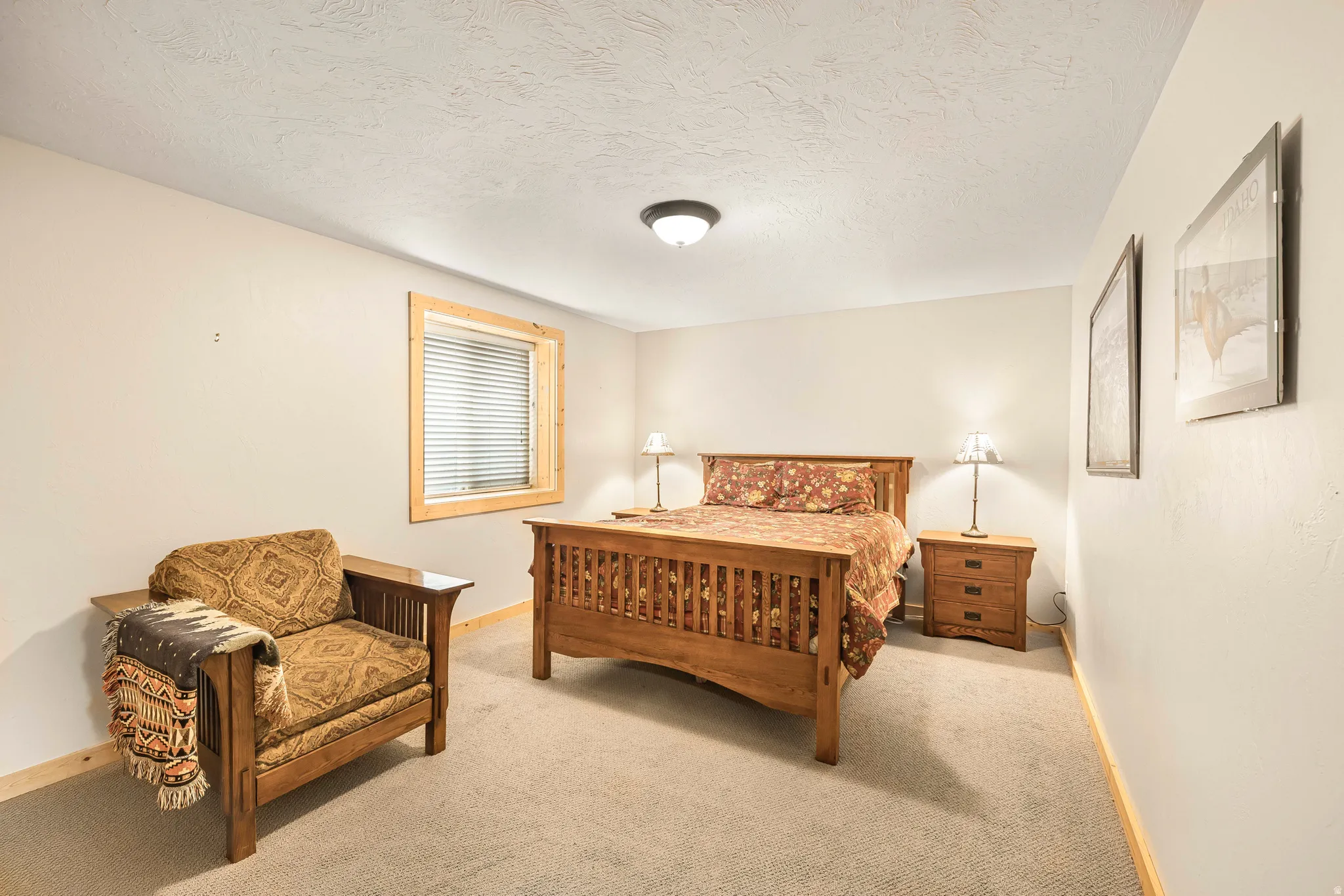 Bedroom featuring carpet floors and a textured ceiling
