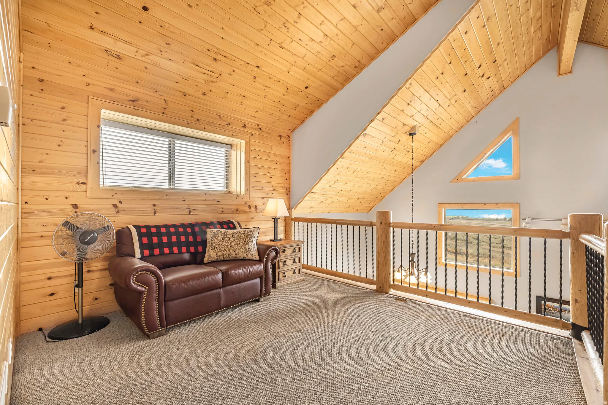 Sitting room featuring wood ceiling, wood walls, and carpet flooring
