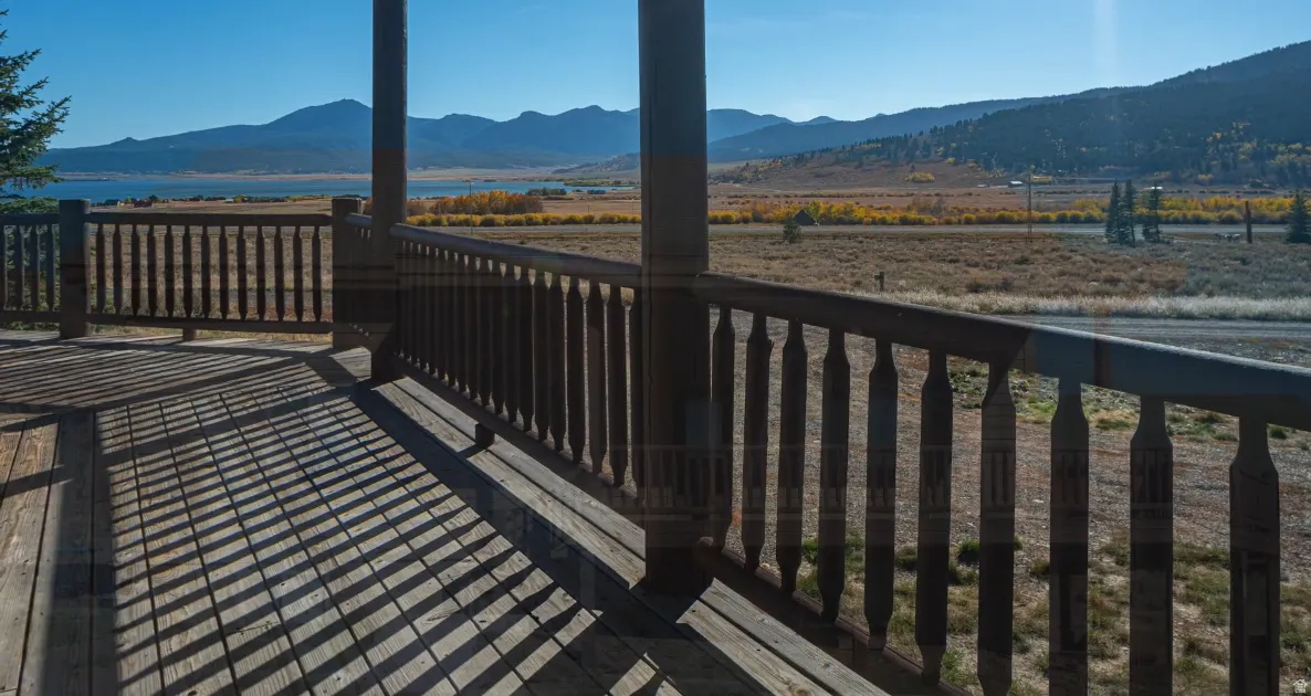 Deck featuring a water and mountain view