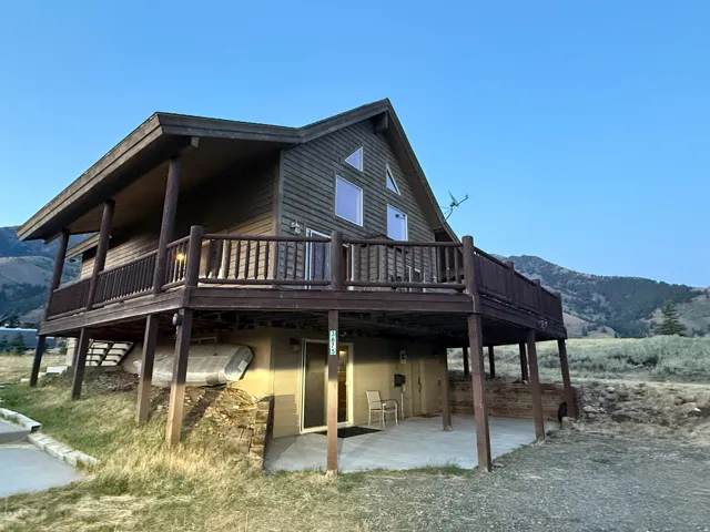 View of property exterior featuring a deck with mountain view and a patio area