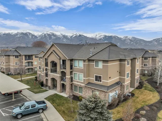 View of property featuring a mountain view and uncovered parking