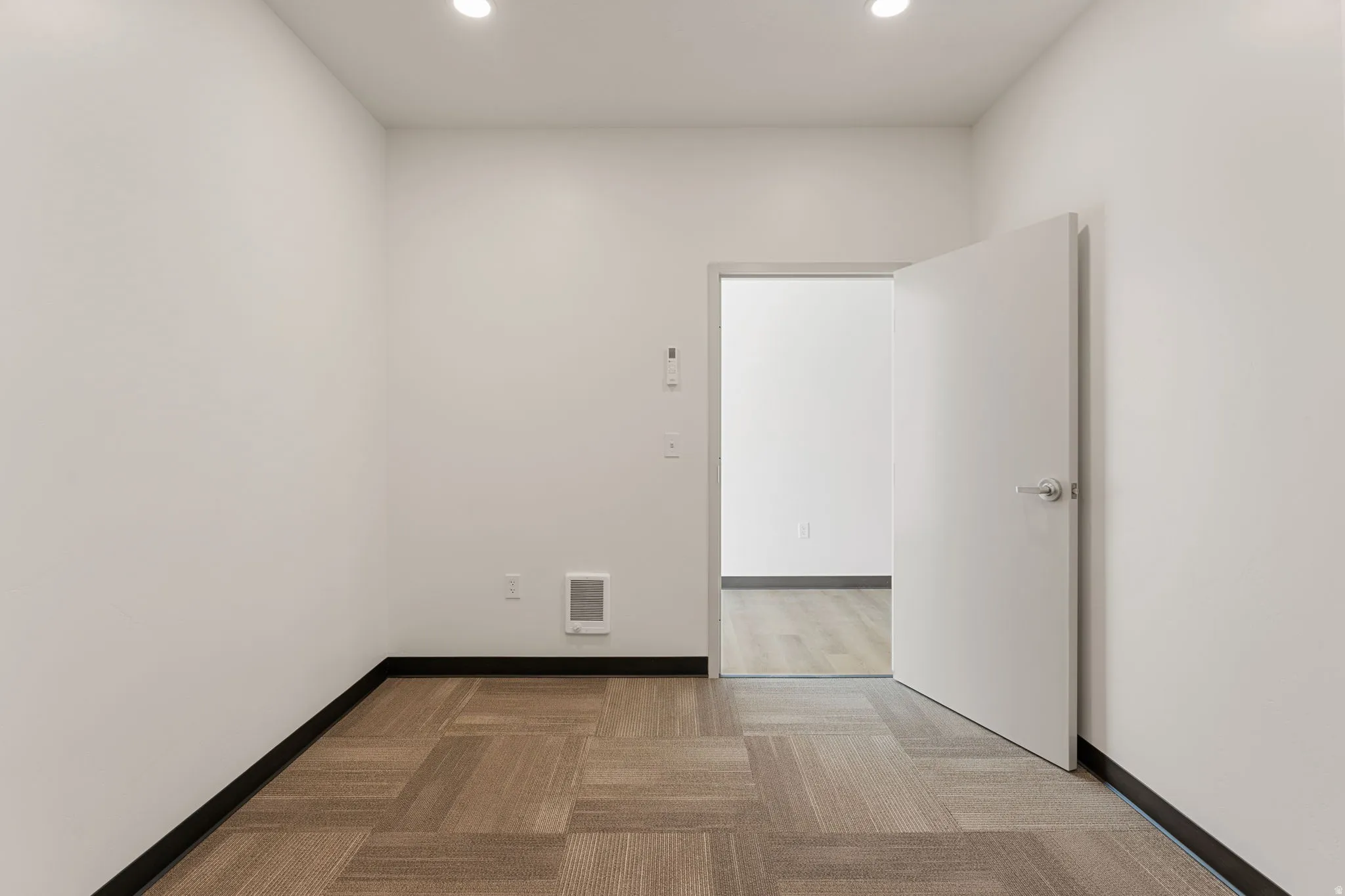 Spare room with light colored carpet and recessed lighting